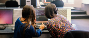 Technovation Girls Mentor and student share a computer screen showing code