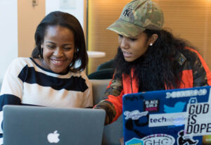 Girls working together on laptops