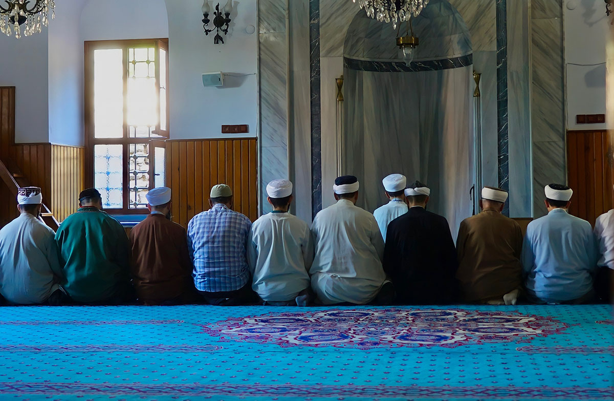 men at mosque praying