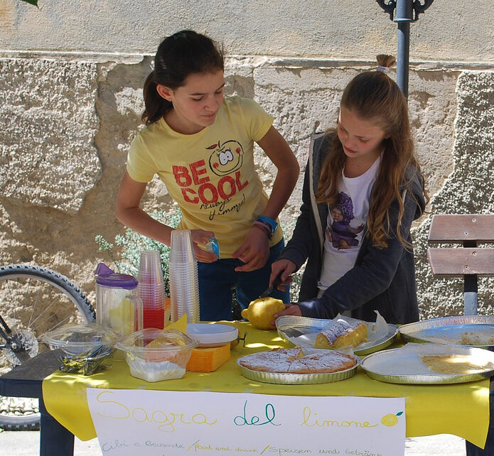 2 girls working a lemonade stand