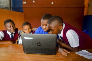 girls coding around laptop