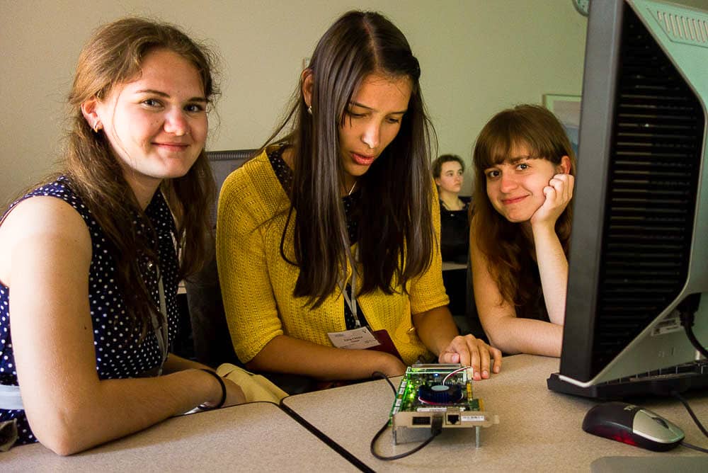 girls looking at hardware device