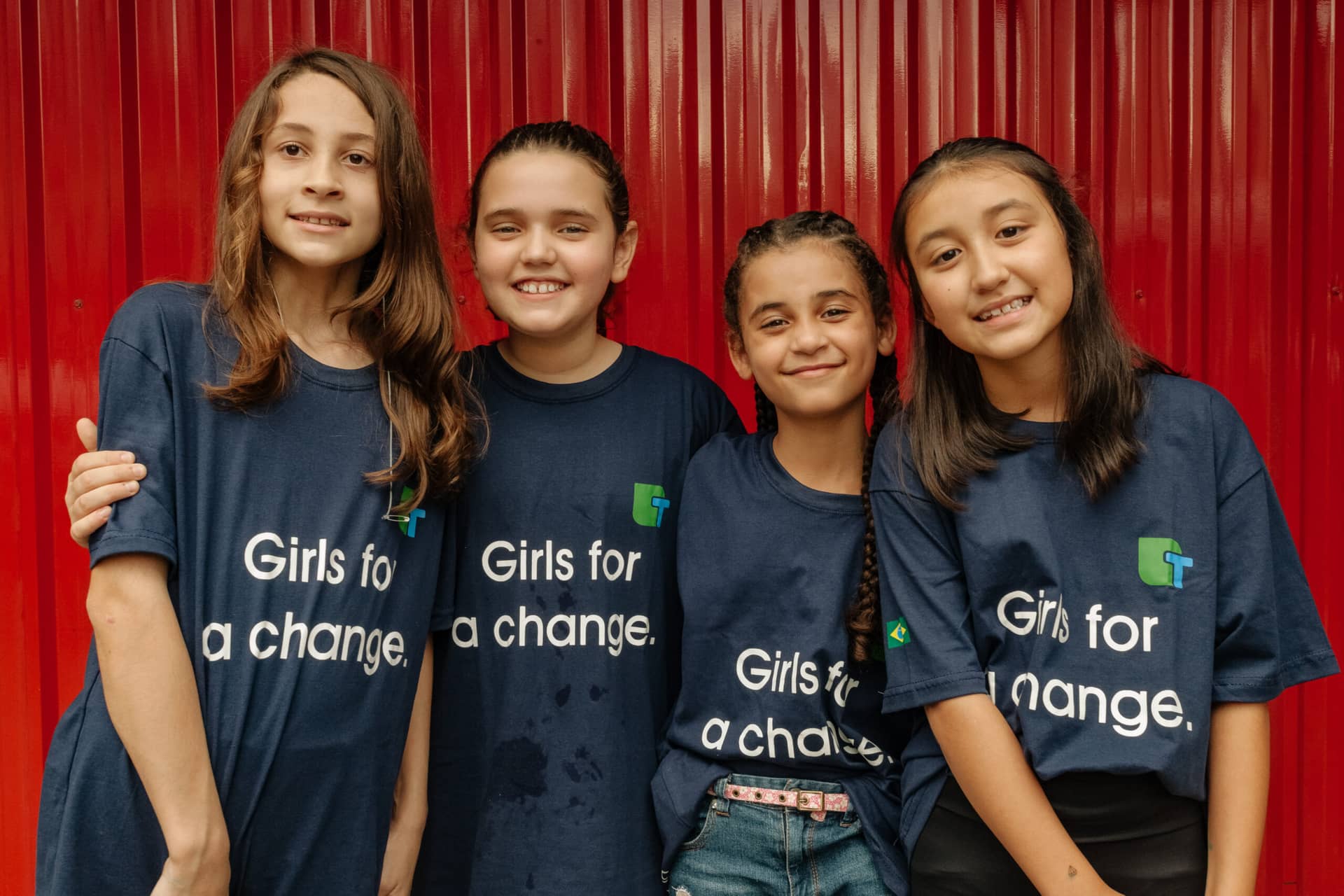 4 girls with girls for a change t-shirts on