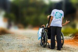 girl helping man in wheelchair