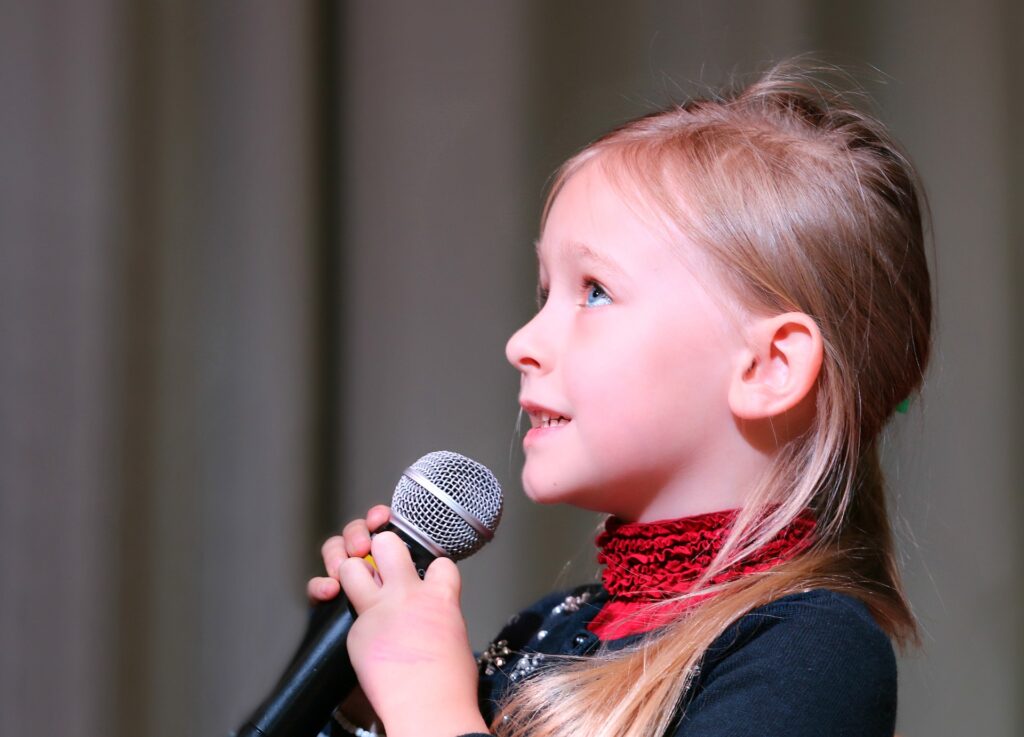 girl speaking into microphone