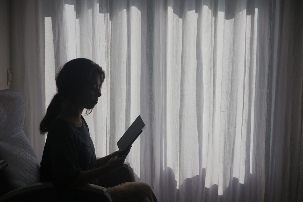 girl reading from book