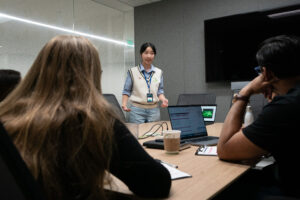 back of 2 heads, girls in white vest facing them