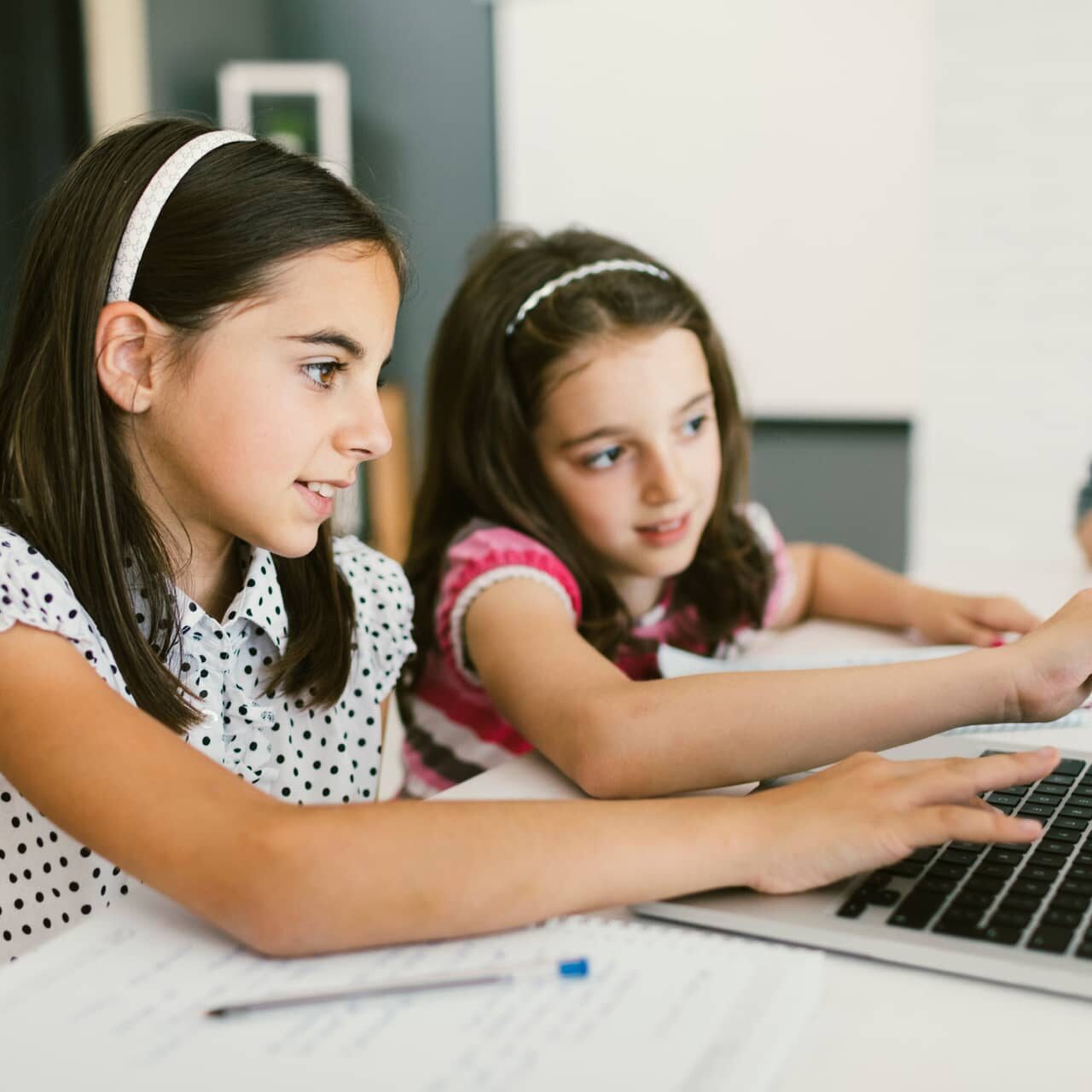 two girls working at a computer